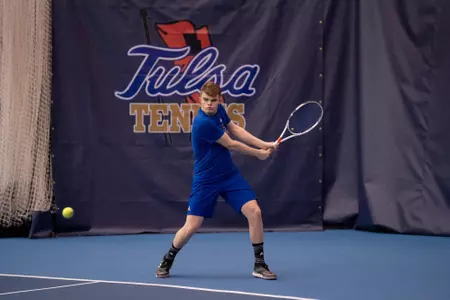 men's tennis player swinging a racket