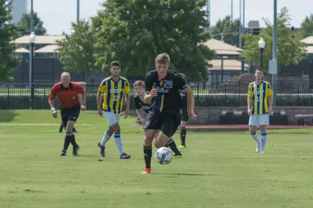 Austen Schweinert kicking a soccer ball