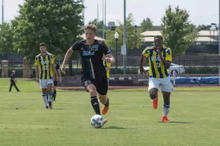 Austen Schweinert kicking a soccer ball