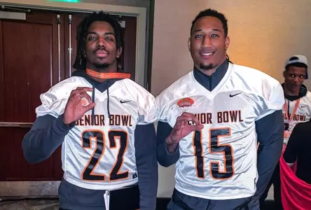 Reggie Robisnon II and Trevis Gipson pose in their Senior Bowl jerseys