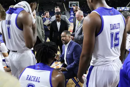 Frank Haith talks strategy with his team