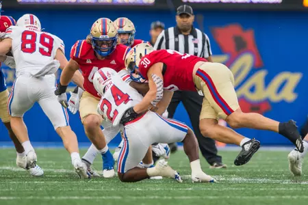 Tulsa Golden Hurricane linebacker Justin Wright (30) and Tulsa Golden Hurricane defensive lineman Owen Ostroski (48) BRETT ROJO/For the University of Tulsa