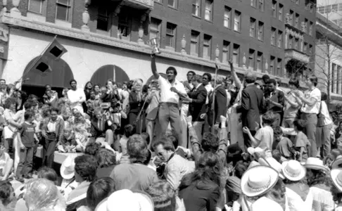 TU Celebration, March 26, 1981.
Coach Nolan Richardson triumphantly brandishes the silver NIT trophy. Tulsa World, March 27, 1981, C1.