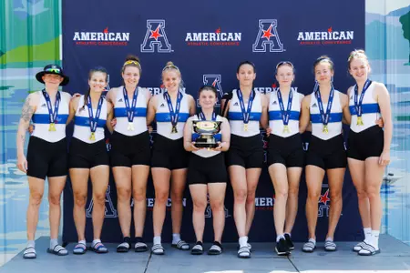 Rowing varsity 8 with 2024 AAC trophy
