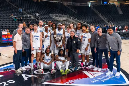 Men's Basketball celebrates winning the Acrisure Holiday Invitational