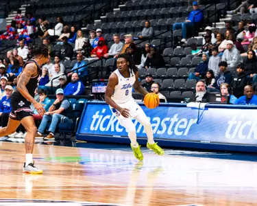 Ade Popoola dribbles up the court against NMSU