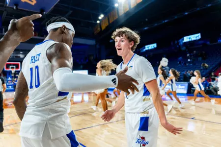 Cal Conroy and Tylen Riley celebrate Tulsa's win over Manhattan Christian