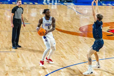 Romad Dean looks to pass against Manhattan Christian