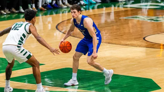 Miles Barnstable dribbles up the court against Charlotte