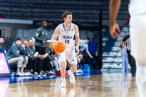 Miles Barnstable dribbles up the court against Rice