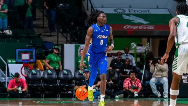 Ade Popoola dribbles up the court against North Texas