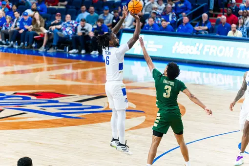 Romad Dean shoots a three against Charlotte