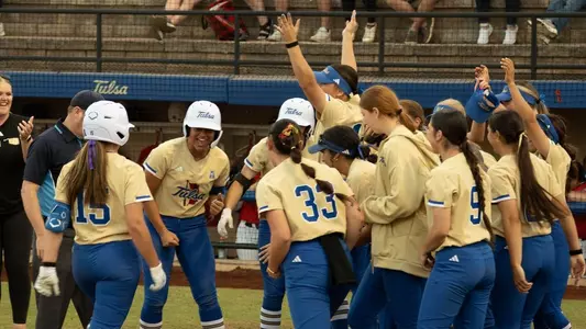 Emma Vickrey crosses home plate to celebrate a walk-off home run with her teammates