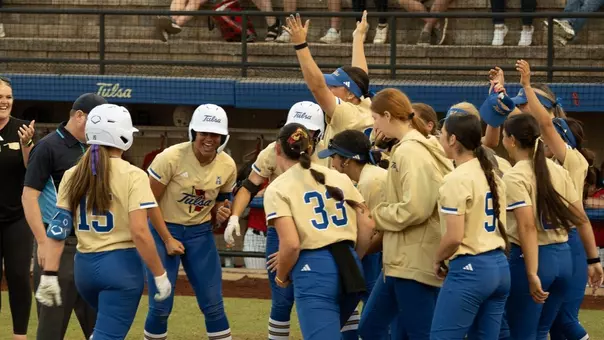 Emma Vickrey crosses home plate to celebrate a walk-off home run with her teammates