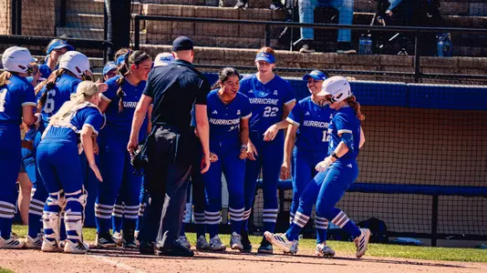 The team celebrates Maci Cole's home run against South Florida