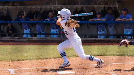 Faith Russell follows through on a home run swing against ECU