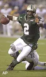 Quarterback Jeff Aaron eludes the grasp of a Bobcat defender.