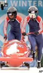 Jill Bakken, right, and Vonetta Flowers push USA-2 out of the start in the first heat during the women's two-person bobsled final. USA-2 set a track record in the first heat and cruised to the gold medal.