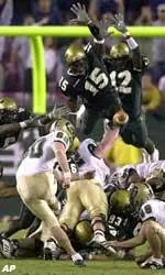 UAB kicker Nick Hayes (60) follows through on the game-winning field goal despite the defensive efforts of South Florida's Huey Whittaker (15) and Javan Camon (12) during the final seconds of the game.