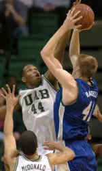 Brandon Tobias blocks a shot by Tulsa's Charles Ramsdell during the first half.