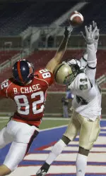 Defensive back Kevin Sanders and SMU wide receiver Bobby Chase reach for a pass in the end zone during the first half in Dallas Tuesday night.