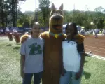 UAB women's basketball players Carmen Guzman (left) and Fatiha Salaam pose with Scooby-Doo at the Mercedes Kids Marathon.