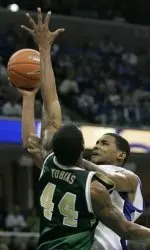 Memphis' Shawne Williams drives to the basket as Brandon Tobias tries to block his shot during the first half.