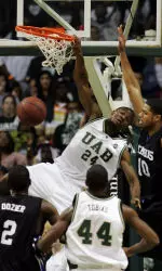 Wen Mukubu dunks over Rodney Carney of Memphis during the first half.