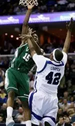 UAB's Frank Holmes (15) goes up for a shot asMemphis' Kareem Cooper (42) defends during the first half. (AP Photo)