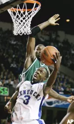 Kentucky's Ramel Bradley tries to shoot in front of Lawrence Kinnard during the first half. Kinnard blocked the shot. (AP Photo/Ed Reinke)
