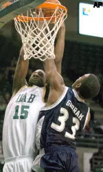 Frank Holmes shoots in front of Rice's Lawrence Ghoram in the first half. (AP Photo/ Birmingham News, Mark Almond)