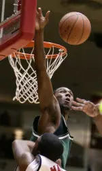 Lawrence Kinnard leaps up to block a shot by Houston's Marcus Malone during the first half.
