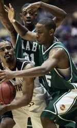 Jeremy Mayfield and Howard Crawford apply pressure to Southern Miss' Sai'Quon Stone in the first half. (AP Photo/Rogelio V. Solis)