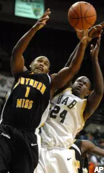 Southern Mississippi's Courtney Beasley and Robert Vaden reach for a rebound in the second half.