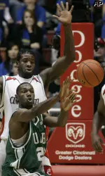 Forward Lawrence Kinnard, front, passes the ball under pressure from Cincinnati forward Mike Williams, rear, during the first half.(AP Photo/Al Behrman)