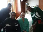 UAB men's basketball players with a patient at the VA hospital.