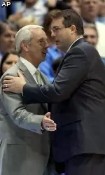 North Carolina head coach Roy Williams, left, greets UAB head coach Jerod Haase, a long-time assistant coach for Williams and former player at Kansas. (AP Photo/Ted Richardson)