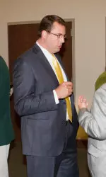 Head men's basketball coach Jerod Haase talking with supporters at the 2012 Athletics Auction.