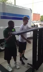 UAB's Karl Moton and K.C. Whitaker seen here moving a new bed into the Ronald McDonald House on Friday.