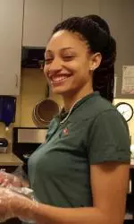 UAB women's basketball player Kasey Drayton seen here serving meals on Thursday.
