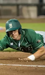 Freshman Riley McCown dives back into first base.