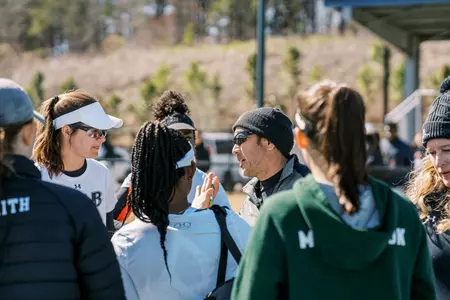 Head coach Mark Tjia discussing the game plan with the girls.