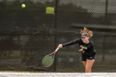 Maggie White hits a serve.