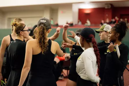 The UAB women's tennis team gathers for a break down.