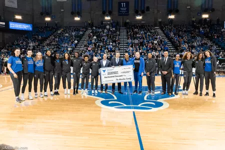 UB Women's Basketball is presented with a check from the Murchie Family for $100,000