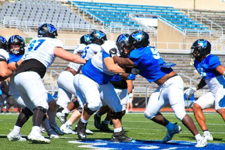 UB Football offensive and defensive line