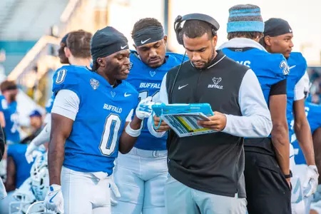 COACH HAYNES LOOKS OVER A PLAY WITH CUFF AND SNOW