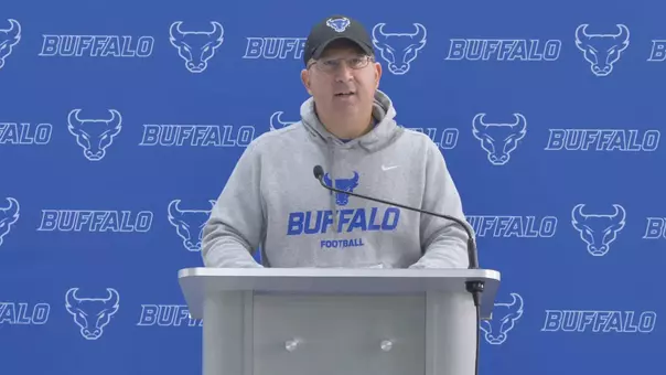 Pete Lembo speaking at a podium