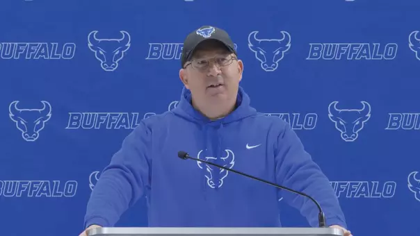 Pete Lembo speaking at a podium