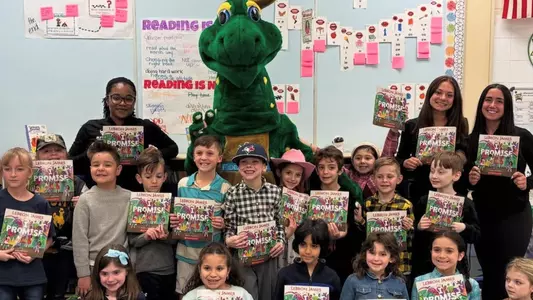 UB Student-Athletes posing with elementary school students
